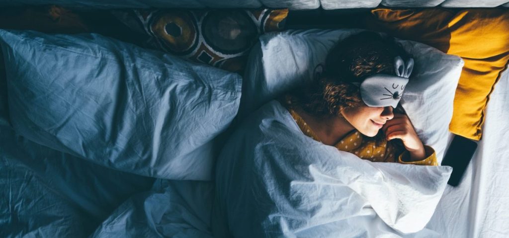 Woman sleeping with a sleep mask on her eyes