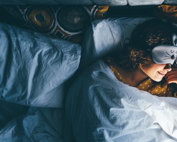 Woman sleeping with a sleep mask on her eyes